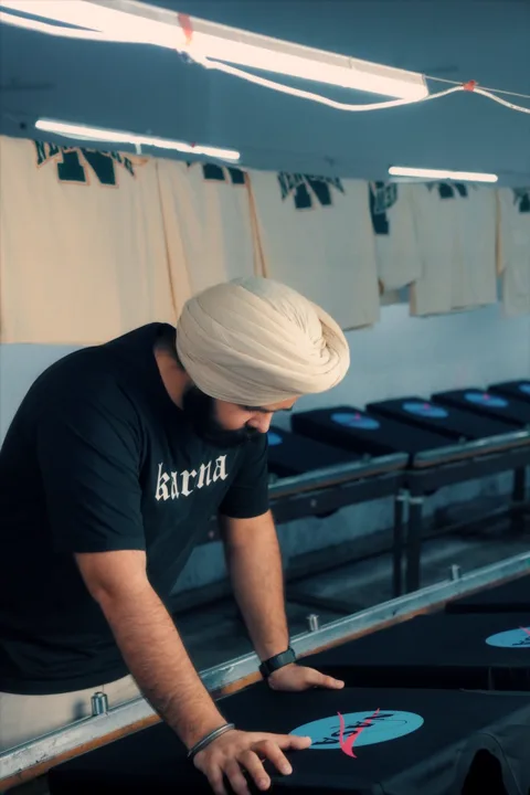 The founder inspecting a print on the press bed